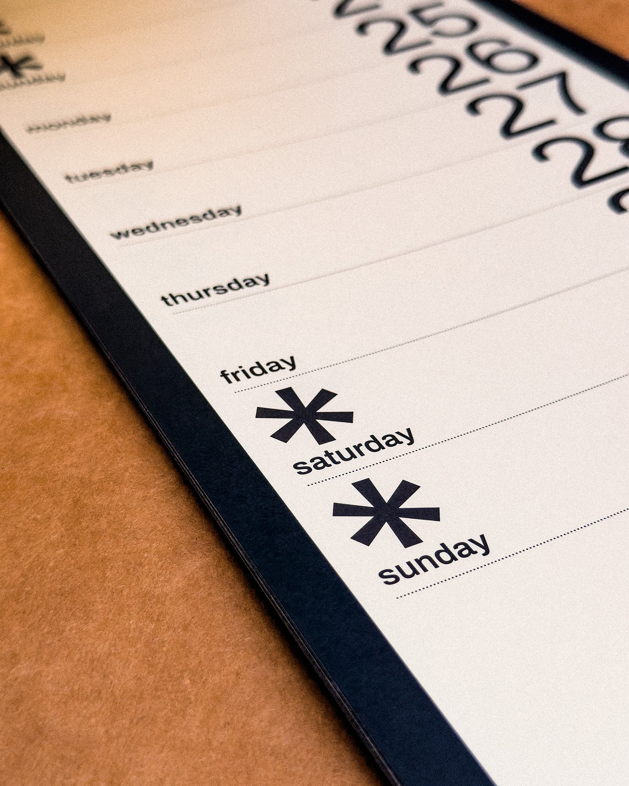 Calendar page showing days of the week with asterisk symbols